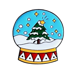 Cartoon Christmas snow globe enamel pin with green tree and falling snow on white background