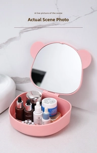 Pink makeup mirror box with bear ears shown on marble bathroom counter
