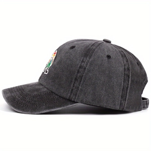 Washed charcoal grey baseball cap with colorful cartoon embroidery at a 45-degree angle