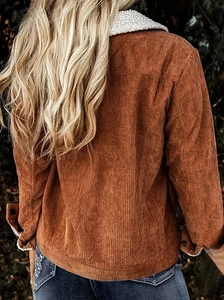 Detail of dark brown corduroy jacket with white sherpa lining and ribbed texture
