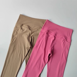 Detail of high-waisted yoga leggings with wide waistband and side pockets in two colors