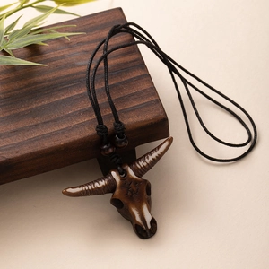 Tribal New Zealand style resin bull skull pendant on adjustable black woven cord necklace