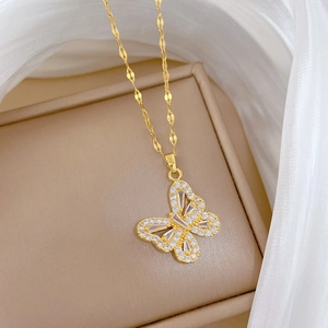 Detailed macro view of butterfly pendant with pavé cubic zirconia and gold-plated chain