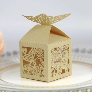 Detail view of light gold butterfly wedding favor box with laser-cut hollow pattern