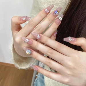 Sparkly pink aurora press-on nails in long coffin shape with rhinestones and crystals