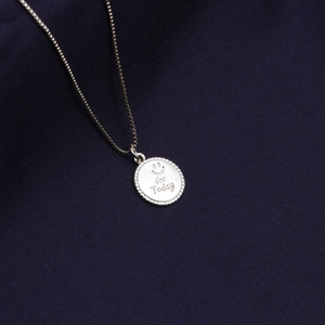 Silver geometric smile pendant necklace with 'for Today' engraving on blue fabric