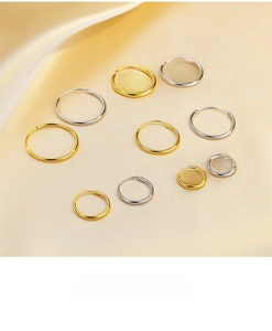Polished S925 sterling silver hoop earrings in various sizes on silk background