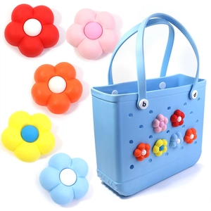 Blue silicone beach tote bag with colorful 3D flower charms and floral accessories