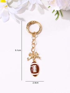Detailed view showing dimensions of football keychain with bow and enamel rugby pendant