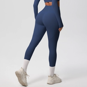 Detail of navy blue high-waisted yoga leggings showing contouring back seams and fabric texture