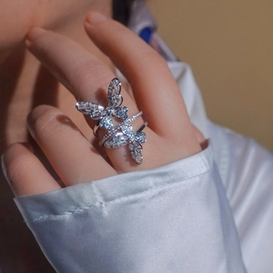 Elegant double butterfly open ring with sparkling cubic zirconia on a female finger