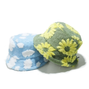 Teddy plush bucket hats with blue cloud and green sunflower patterns for winter warmth
