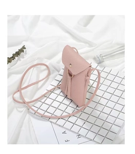 Detailed macro of pink lychee texture PU leather and gold round buckle on mini bag
