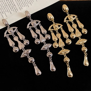 Artistic surrealist gold and silver tassel earrings with textured metal finish