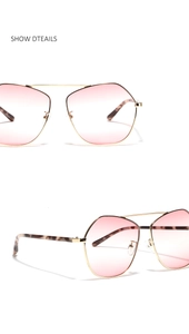 Detail of pilot sunglasses with gold metal frame, pink gradient lenses and tortoiseshell tips
