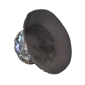 Close-up of black bucket hat featuring colorful dinosaur prints and detailed stitching