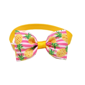 Detail of yellow pet bowtie with pineapple pattern and adjustable buckle for dogs