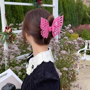 Pink double-layered butterfly hair claw clip worn on hair for an elegant look