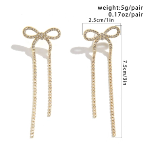 Detailed dimensions of gold bow earrings with tassels and sparkling rhinestones