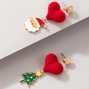 Detail of asymmetrical Christmas earrings with flocked red heart and enamel Santa tree