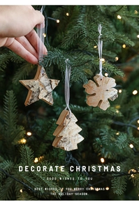 Detail of natural wood Christmas ornaments with stars and snowflakes on a glowing tree