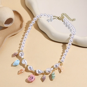 Detail view of multi-layer baroque pearls with colorful conch pendants on golden chain