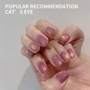 Elegant purple cat eye nail polish with golden shimmer on square oval nails