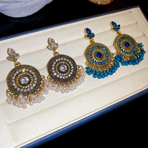 Detailed close-up of Bohemian drop fringe earrings with intricate filigree and beads