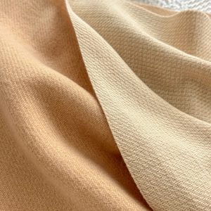 Minimalist double-sided beige and camel cashmere scarf with soft woven texture