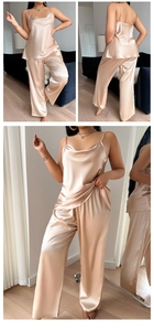 Detail of champagne satin two-piece sleepwear set showing draping texture and silk luster