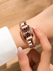 Close-up of elegant rose gold tonneau watch with deep brown dial and diamond markers