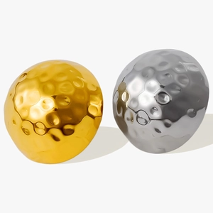 Detailed macro view of 18K gold and silver stud earrings featuring hammered texture finish