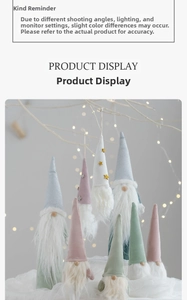 Detail of colorful plush Christmas gnomes with pointed hats hanging on festive branches