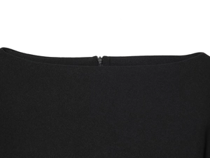 Detail of a black garment featuring a hidden zipper and high-quality fabric texture