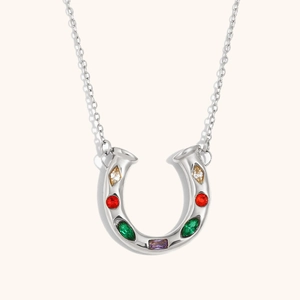 Silver horseshoe pendant necklace with colorful gems on a minimalist background