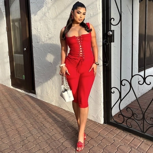 Slim fit red lace-up jumpsuit for women featuring deep V-neck and bodycon silhouette