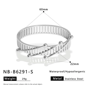 Detail view of hollow geometric bangle with product dimensions and material specs