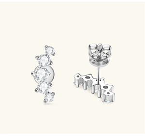 Detailed view of silver curved stud earrings featuring five graduated round clear crystals