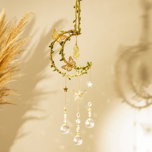 Detail of moon-shaped wind chime with golden butterfly and crystal prism pendant