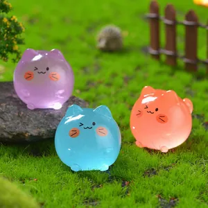 Set of three colorful glowing resin mini kittens on green grass for micro landscape decor