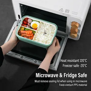 Portable mint green bento lunch box with food inside placed into a microwave
