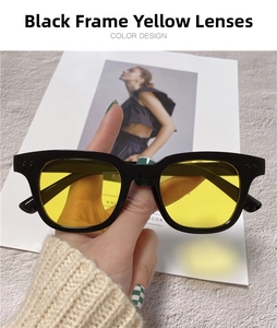 Detail of square black frame sunglasses with yellow lenses and metallic dot accents