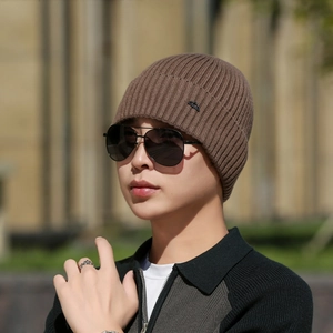 Brown knitted ribbed beanie for men with mountain patch for winter outdoor warmth