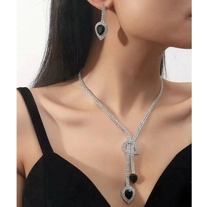 Modella che indossa collana d'argento con cristalli neri a goccia e orecchini nappa