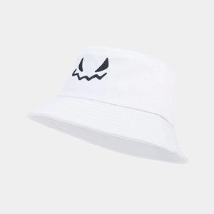 Close-up of Halloween bucket hat with monster face embroidery on white cotton canvas