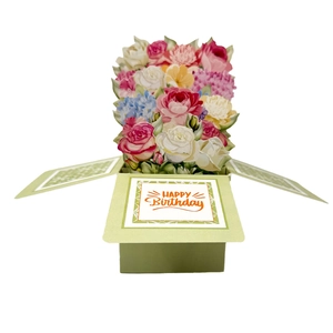 Detail of 3D pop-up birthday card with colorful paper flower bouquet and green base