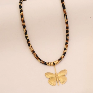 Detail of leopard print cord necklace featuring a textured golden butterfly pendant