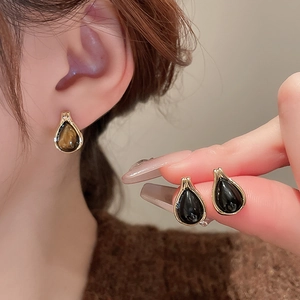Vintage teardrop earrings with tiger eye texture and gold trim for a luxury minimalist look