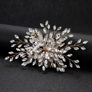 Detail shot of marquise crystal bridal hair comb with gold wire leaf design on black background