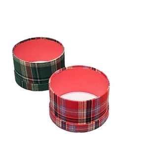Red and green plaid round gift boxes with pink interior lining for Christmas gifts